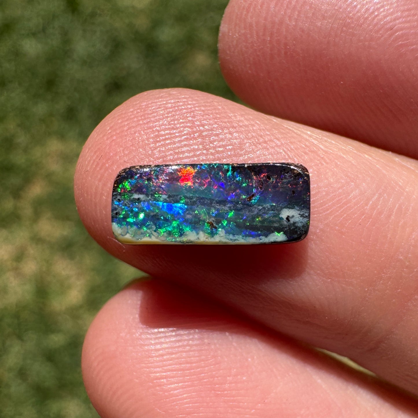 1.31 Ct red and green black gem boulder opal